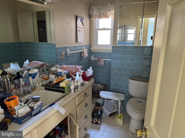 707 Wheatley Dr, Westminster, MD 21157 - half bath with vanity, tile patterned flooring, wainscoting, tile walls, and toilet