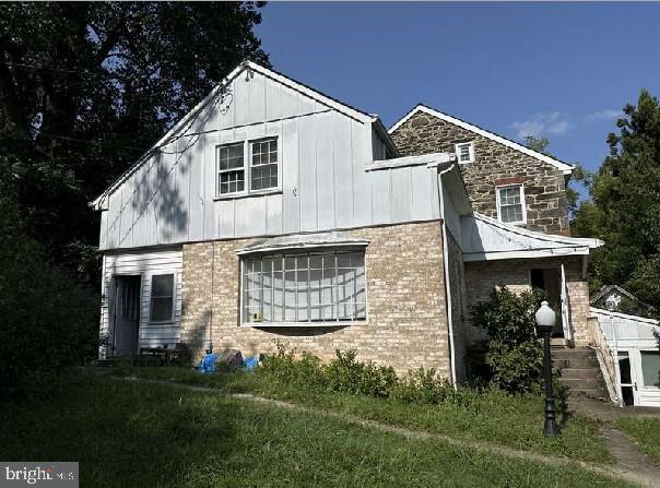 view of side of home with a yard