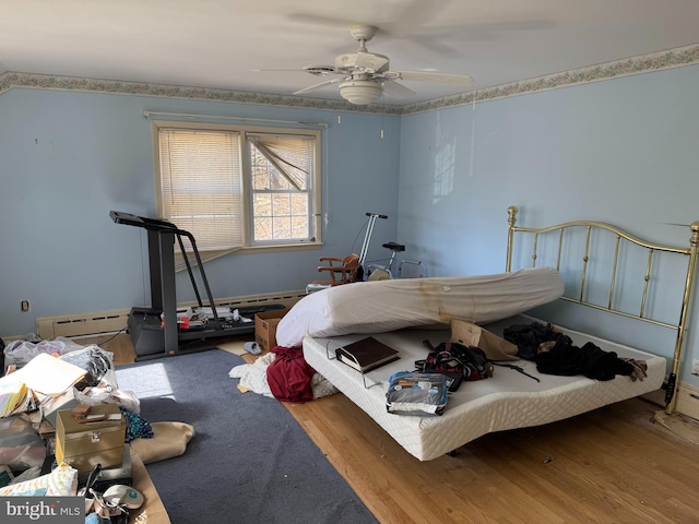 707 Wheatley Dr, Westminster, MD 21157 - bedroom with a baseboard radiator, ceiling fan, and wood finished floors