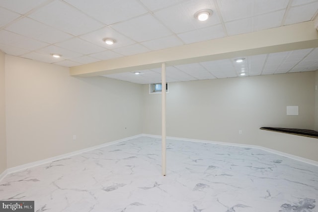 basement featuring a paneled ceiling