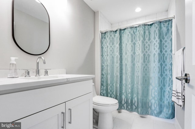 bathroom with tile patterned floors, curtained shower, vanity, and toilet