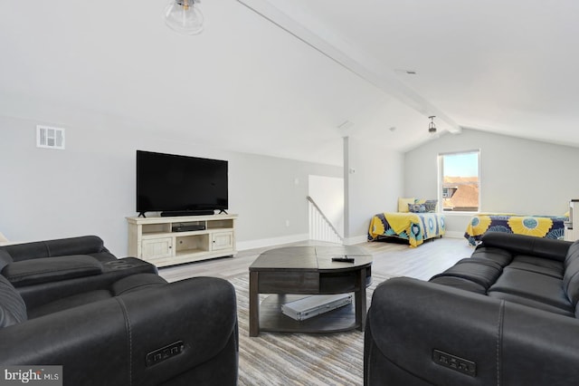 living room featuring lofted ceiling with beams and light wood-type flooring