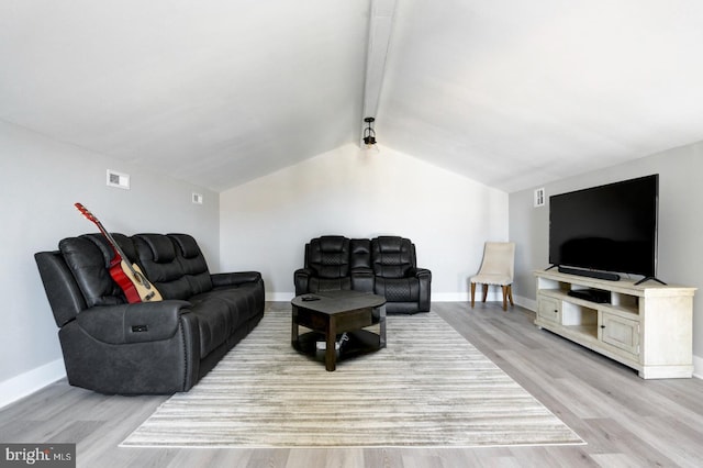 living room with lofted ceiling with beams and light hardwood / wood-style floors