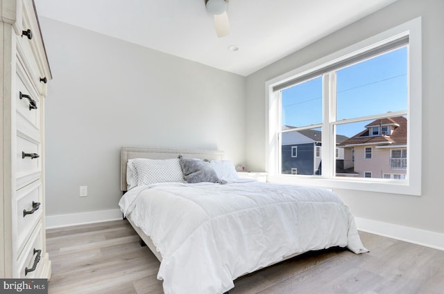 bedroom with ceiling fan and light hardwood / wood-style floors