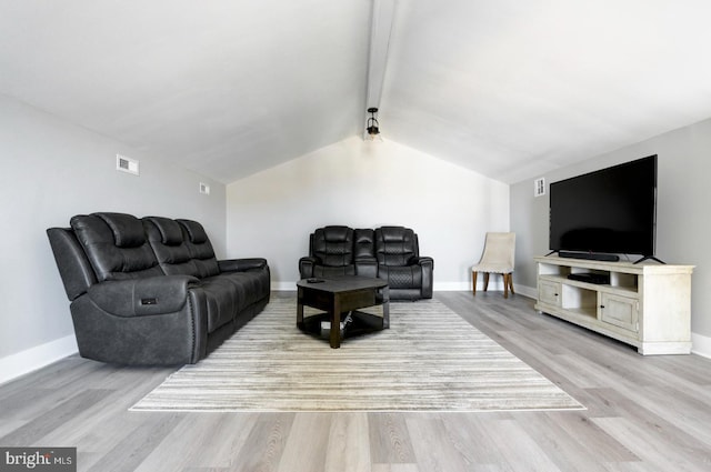 living room featuring vaulted ceiling with beams and light hardwood / wood-style flooring