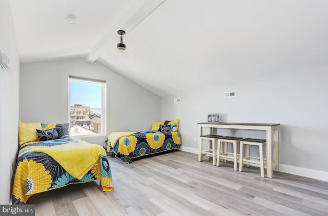 bedroom featuring vaulted ceiling with beams and light hardwood / wood-style floors