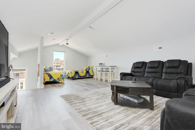 living room featuring vaulted ceiling with beams and light hardwood / wood-style floors