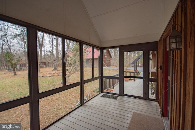 unfurnished sunroom featuring a healthy amount of sunlight and lofted ceiling