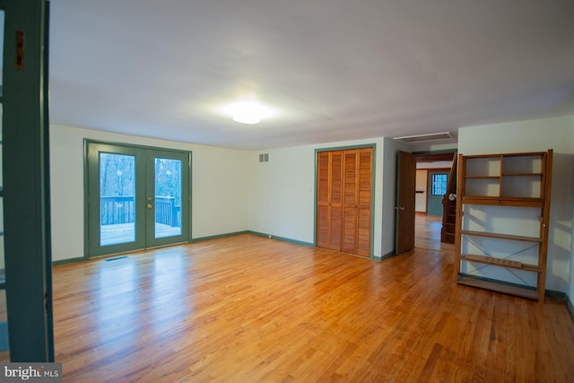 unfurnished room featuring hardwood / wood-style floors and french doors