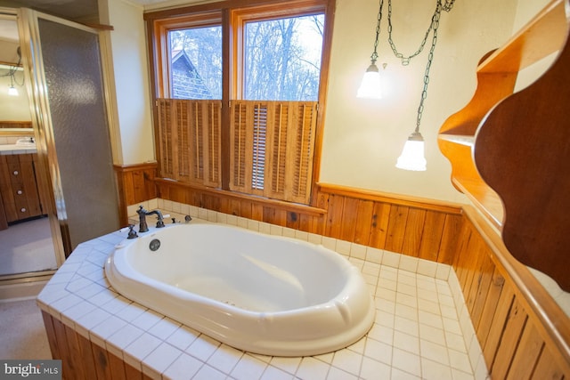 bathroom featuring separate shower and tub