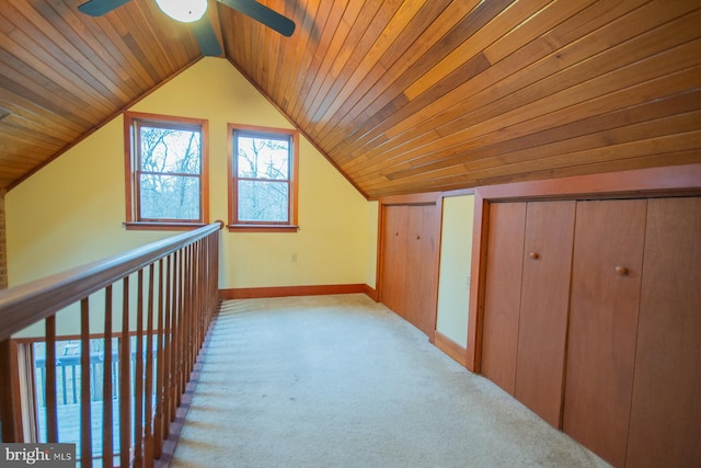 corridor featuring light carpet, wood ceiling, and vaulted ceiling