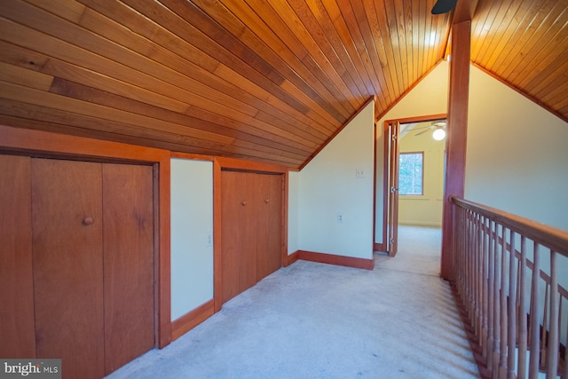 additional living space featuring lofted ceiling, light colored carpet, and wooden ceiling