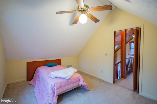 bedroom featuring light carpet, vaulted ceiling, and ceiling fan