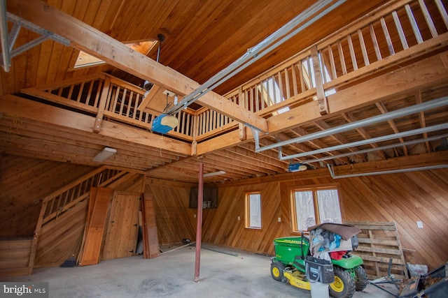 garage with wooden walls and a garage door opener