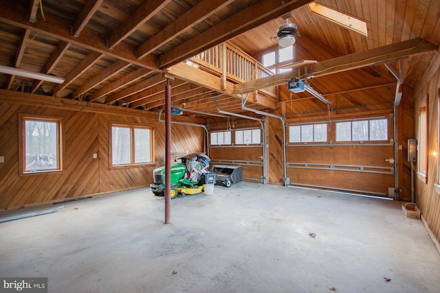 garage with wood ceiling, wooden walls, and a garage door opener