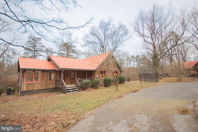 view of side of home with covered porch