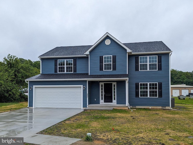 view of front of house featuring a front yard and a garage