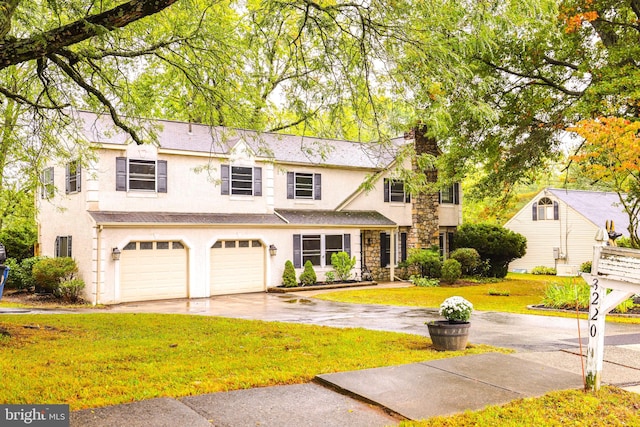 view of front of house featuring a garage and a front lawn