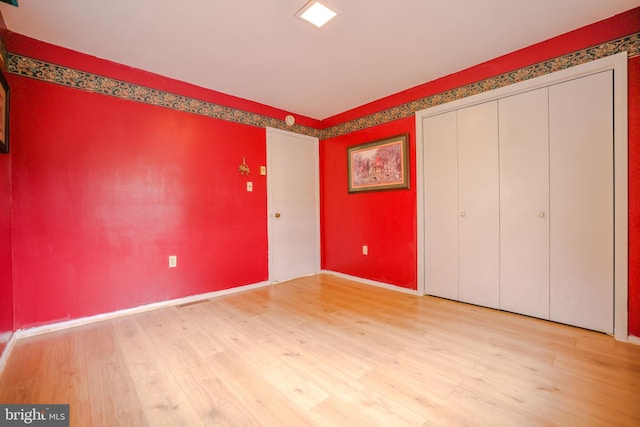 unfurnished bedroom with light wood-type flooring