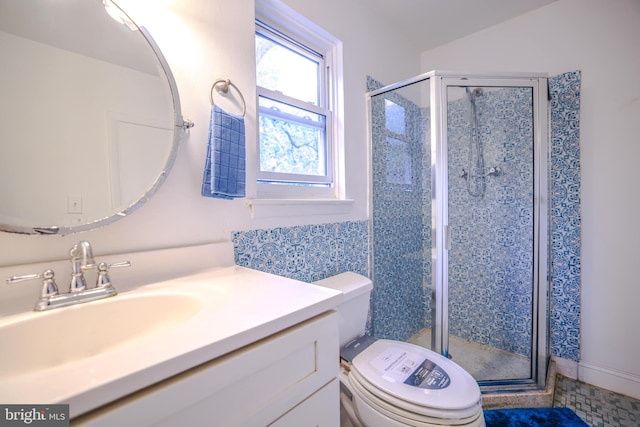 bathroom with vanity, toilet, and walk in shower