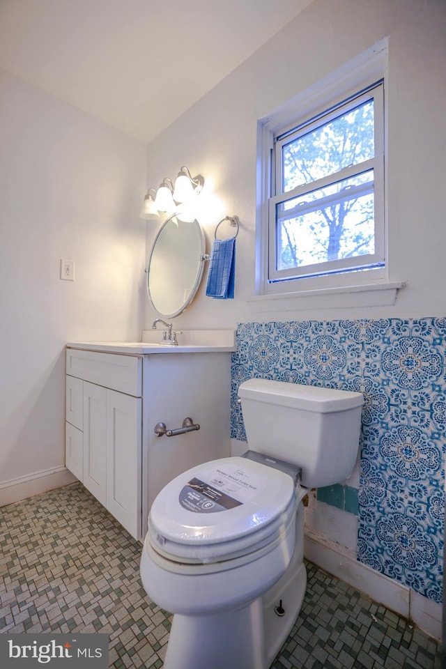 bathroom with tile patterned floors, vanity, and toilet