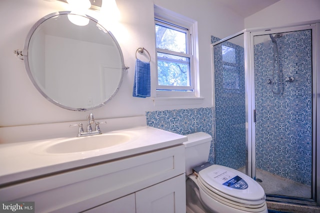 bathroom featuring vanity, toilet, and walk in shower