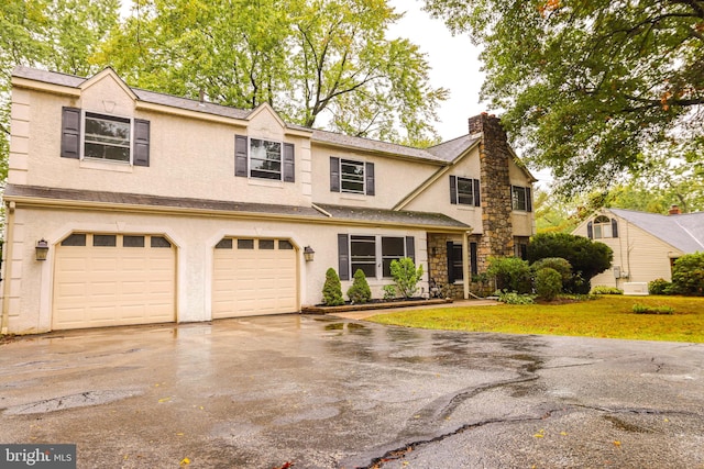 view of front of house featuring a garage and a front yard