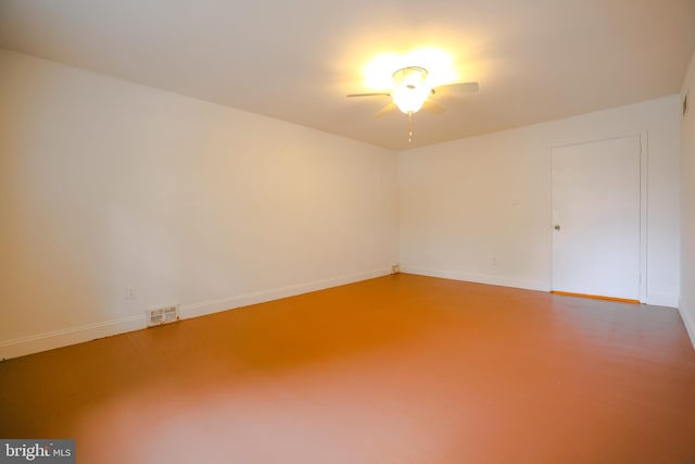 unfurnished room with concrete flooring