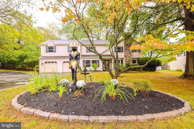 view of front of home with a garage and a front lawn