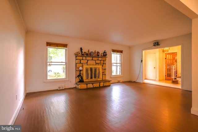 unfurnished living room featuring a fireplace and hardwood / wood-style floors