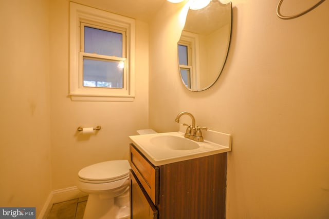 bathroom featuring tile patterned floors, vanity, and toilet