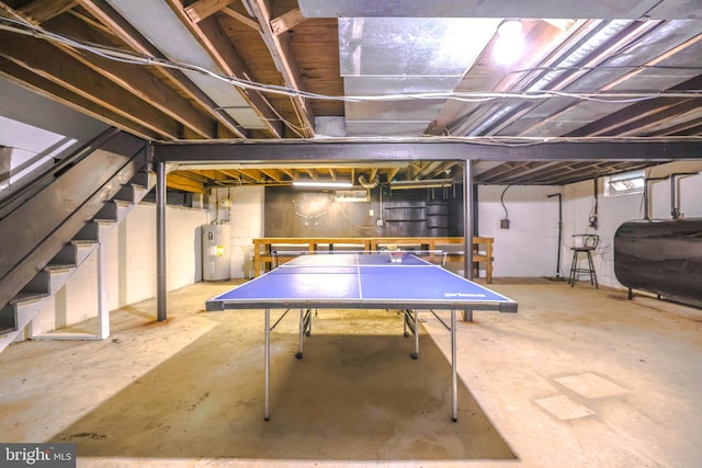 playroom featuring concrete floors and water heater