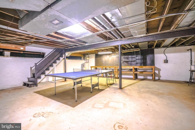 playroom featuring water heater and concrete floors