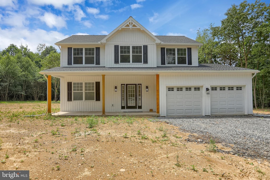 view of front of property with a porch and a garage