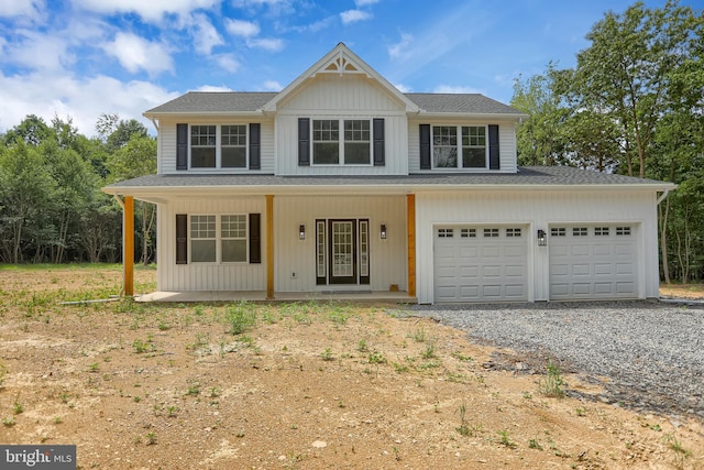 view of front of property with a porch and a garage