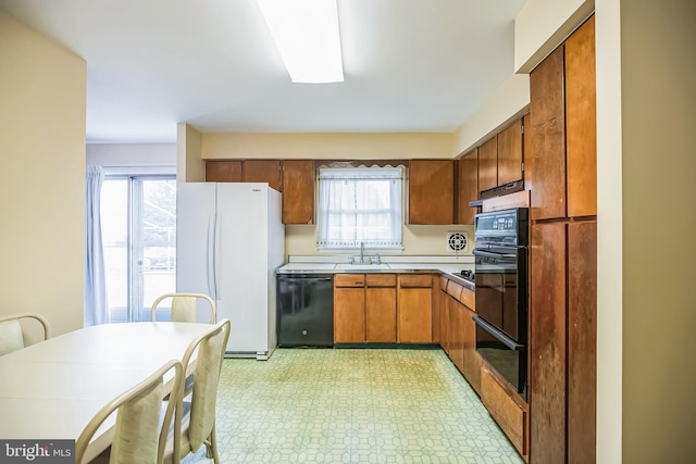 kitchen with black appliances, sink, and a wealth of natural light