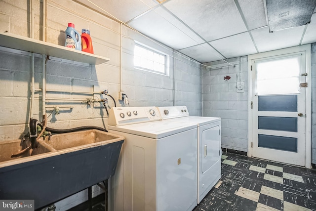 laundry room with washer and clothes dryer, a healthy amount of sunlight, and sink