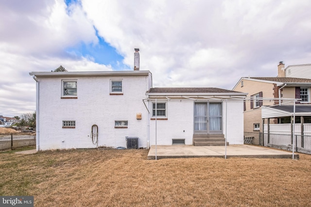 rear view of property featuring a yard, a patio, and central AC unit