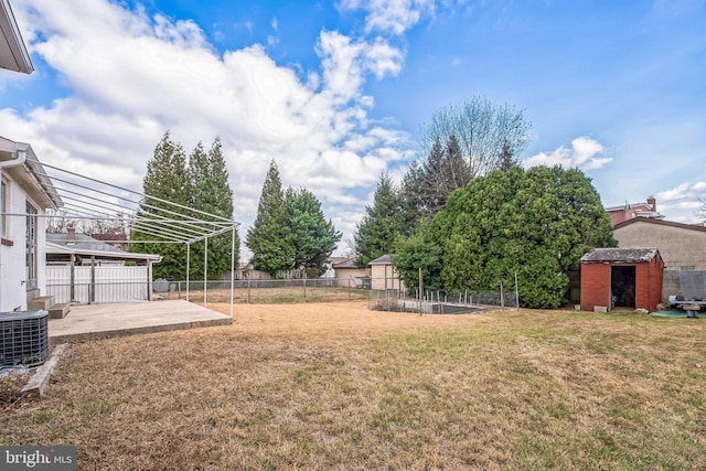 view of yard featuring a patio area, a storage shed, and central AC