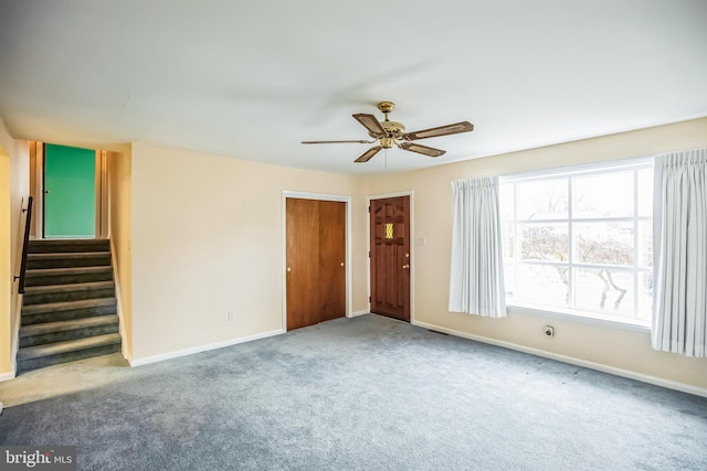 carpeted empty room featuring ceiling fan