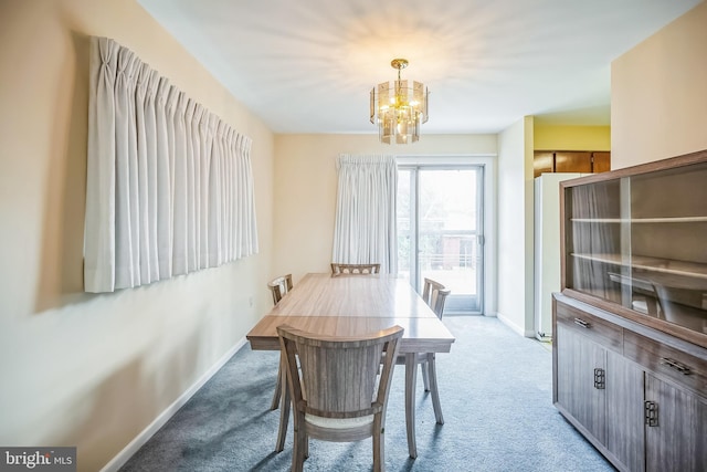 dining space with light carpet and a chandelier