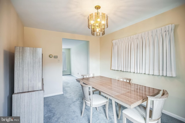 dining room featuring carpet floors and a notable chandelier