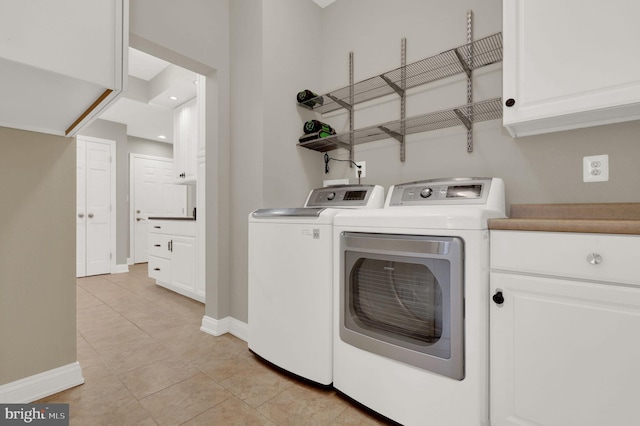 laundry area featuring light tile patterned flooring and separate washer and dryer