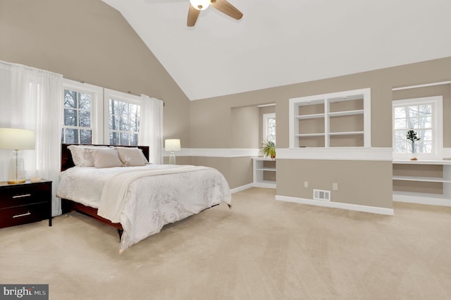 carpeted bedroom featuring ceiling fan and high vaulted ceiling