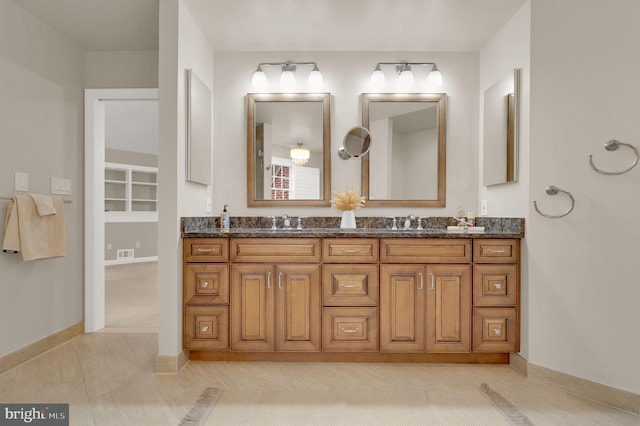 bathroom with tile patterned floors and vanity