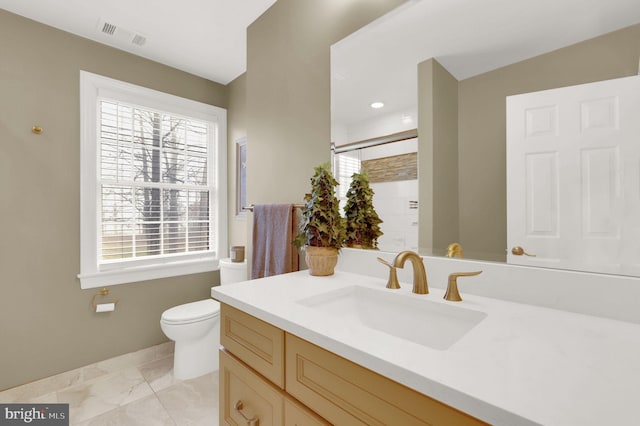 bathroom with vanity, toilet, and walk in shower