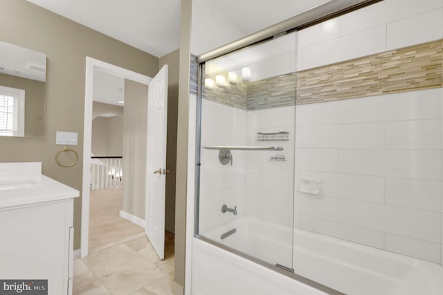 bathroom featuring vanity and enclosed tub / shower combo