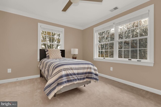 bedroom featuring ceiling fan, carpet floors, and ornamental molding