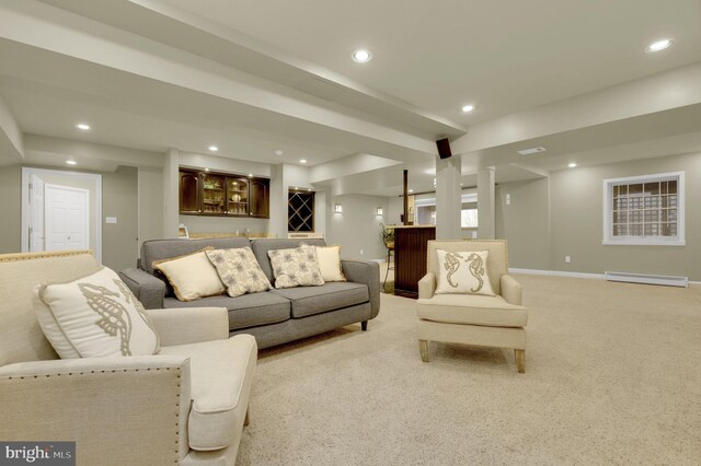 carpeted living room featuring indoor bar and baseboard heating