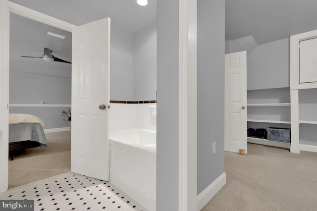 bathroom with ceiling fan and a washtub